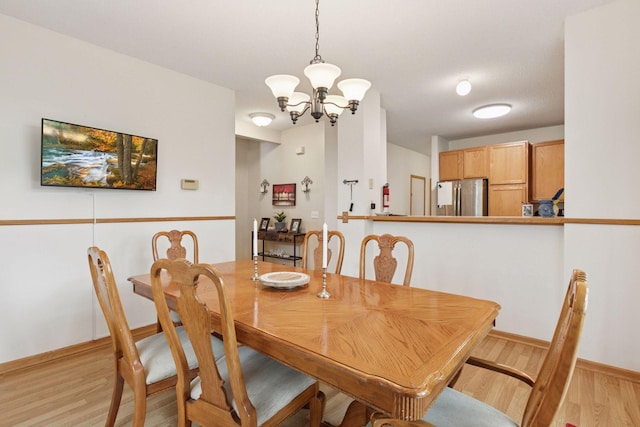 9026 Merrimac Ln N, Maple Grove, MN 55311 - dining space featuring a chandelier, light wood-type flooring, and baseboards