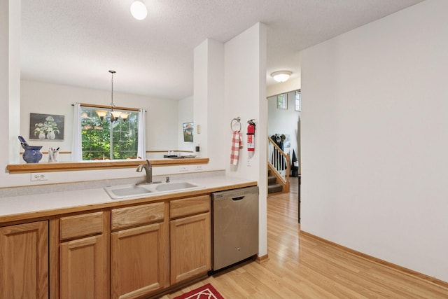 9026 Merrimac Ln N, Maple Grove, MN 55311 - kitchen with dishwasher, a sink, light wood-style flooring, light countertops, and a textured ceiling