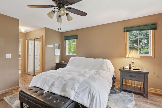 9026 Merrimac Ln N, Maple Grove, MN 55311 - bedroom with wood finished floors, a closet, baseboards, and ceiling fan