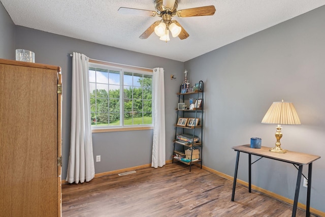 9026 Merrimac Ln N, Maple Grove, MN 55311 - home office featuring wood finished floors, baseboards, a textured ceiling, and ceiling fan