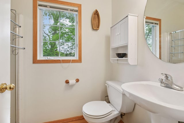 9026 Merrimac Ln N, Maple Grove, MN 55311 - bathroom featuring a sink, toilet, and a shower