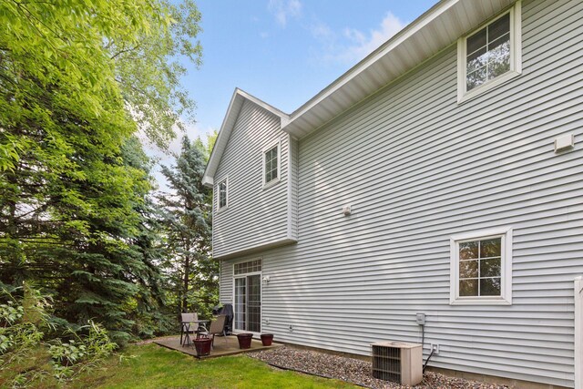 9026 Merrimac Ln N, Maple Grove, MN 55311 - view of side of property with a patio area and central air condition unit