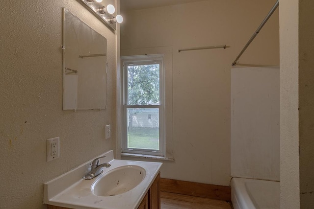 717 2nd Ave NE, Waseca, MN 56093 - full bathroom with vanity and wood finished floors