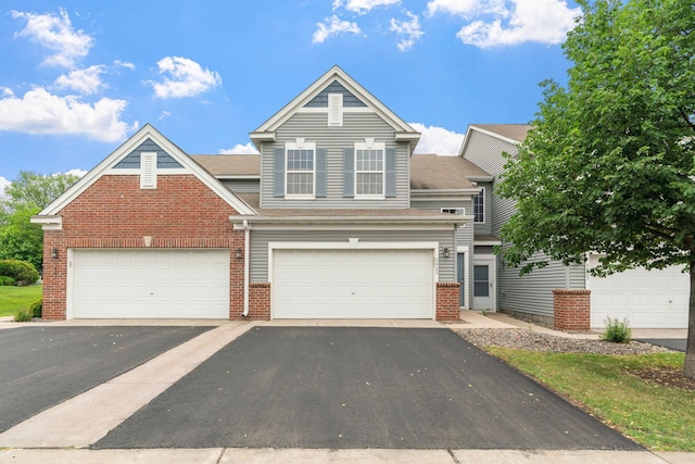 5423 Elm Grove Ave, New Hope, MN 55428 - view of front of property with asphalt driveway, brick siding, and a shingled roof