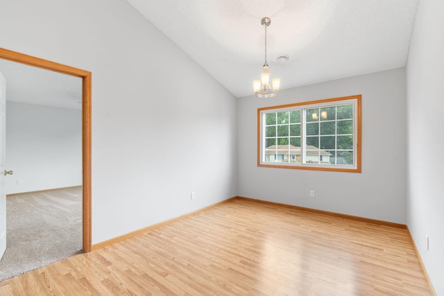 5423 Elm Grove Ave, New Hope, MN 55428 - unfurnished room with wood finished floors, a chandelier, and lofted ceiling