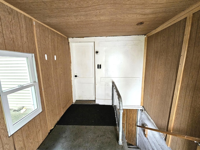702 Junius Ave, Fergus Falls, MN 56537 - corridor featuring wood ceiling, wooden walls, and an upstairs landing