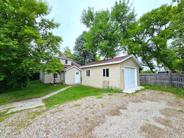 702 Junius Ave, Fergus Falls, MN 56537 - rear view of house with an outbuilding, a detached garage, and driveway