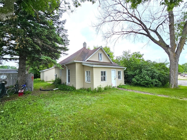 702 Junius Ave, Fergus Falls, MN 56537 - view of property exterior with a chimney and a yard