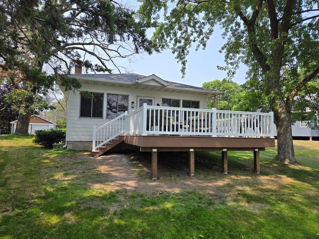 6567 Shore Trl N, Forest Lake, MN 55025 - back of property with a lawn, a wooden deck, a chimney, and stairs
