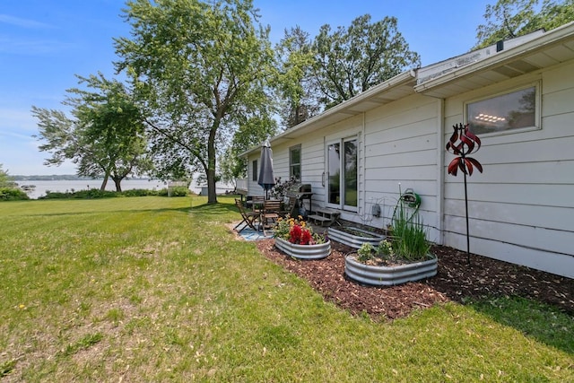 6567 Shore Trl N, Forest Lake, MN 55025 - view of grassy yard with a water view and a patio