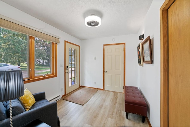 6567 Shore Trl N, Forest Lake, MN 55025 - doorway with light wood finished floors, plenty of natural light, a baseboard radiator, and a textured ceiling