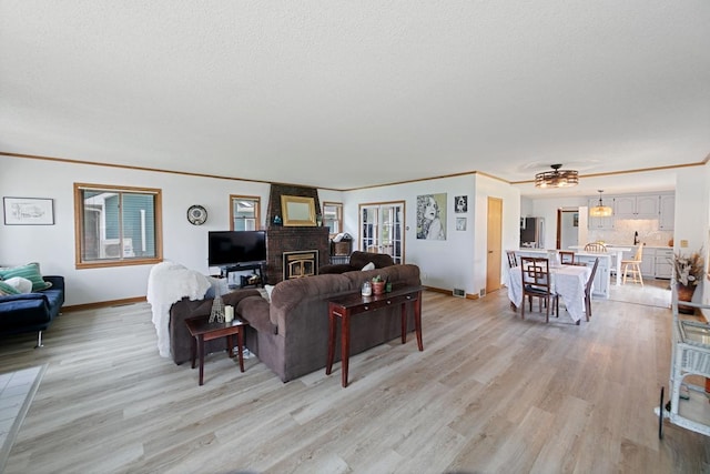 6567 Shore Trl N, Forest Lake, MN 55025 - living area with light wood-style flooring, crown molding, ceiling fan, and a textured ceiling