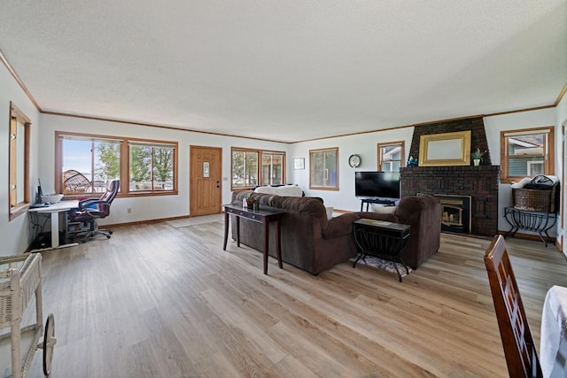 6567 Shore Trl N, Forest Lake, MN 55025 - living area with crown molding, light wood finished floors, a fireplace, and a desk