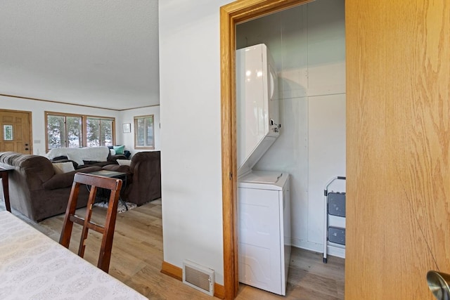 6567 Shore Trl N, Forest Lake, MN 55025 - laundry room with stacked washer and clothes dryer and wood finished floors