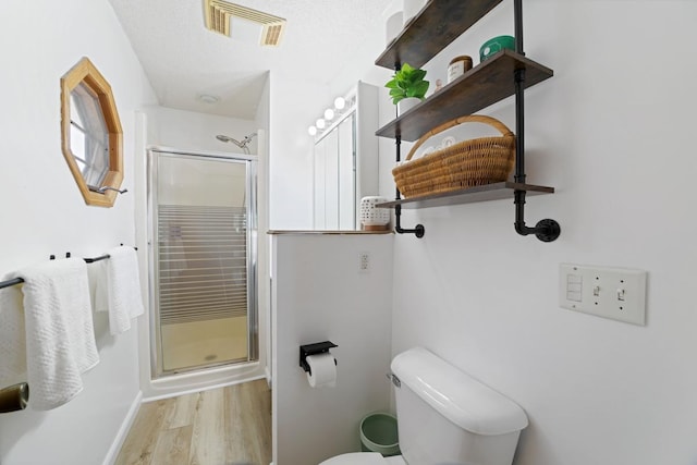 6567 Shore Trl N, Forest Lake, MN 55025 - bathroom featuring a stall shower and wood finished floors