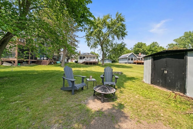 6567 Shore Trl N, Forest Lake, MN 55025 - view of grassy yard featuring a fire pit, a shed, and a wooden deck