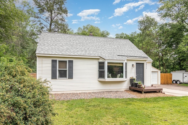 2211 108th Ave NW, Coon Rapids, MN 55433 - view of front of home with a shingled roof, a garage, and an outbuilding