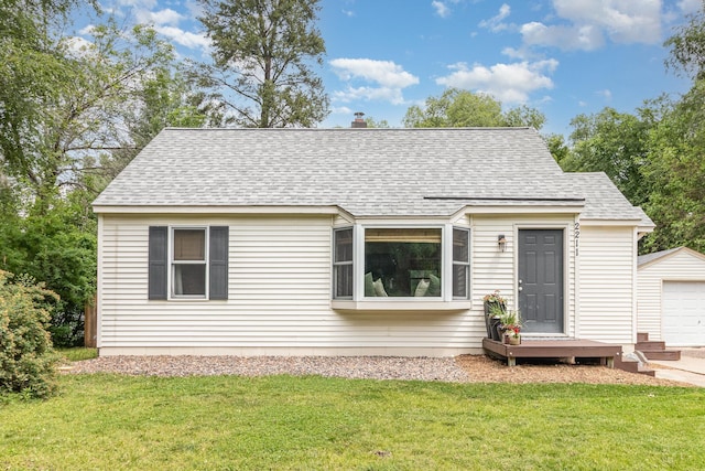 2211 108th Ave NW, Coon Rapids, MN 55433 - view of front of property with roof with shingles, a front lawn, and a detached garage