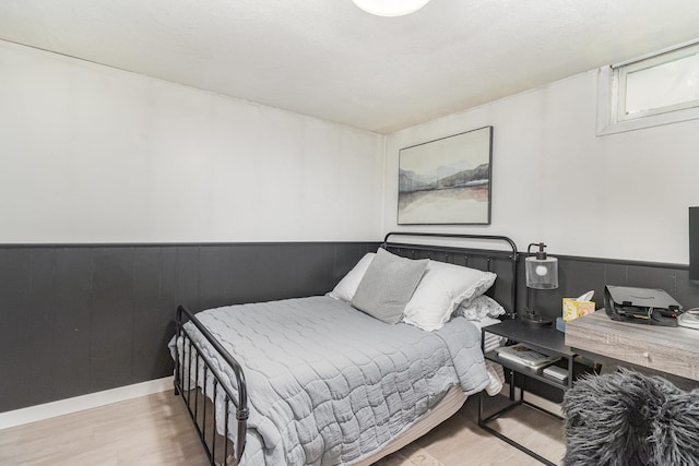 2211 108th Ave NW, Coon Rapids, MN 55433 - bedroom featuring wood finished floors and a wainscoted wall