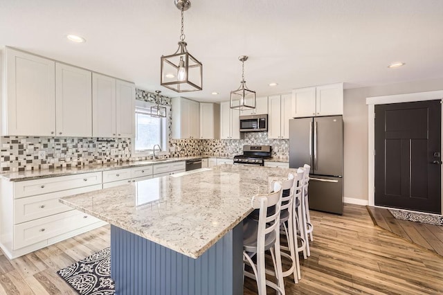 2865 Pilot Knob Rd, Eagan, MN 55121 - kitchen with appliances with stainless steel finishes, a sink, light wood-type flooring, white cabinets, and recessed lighting