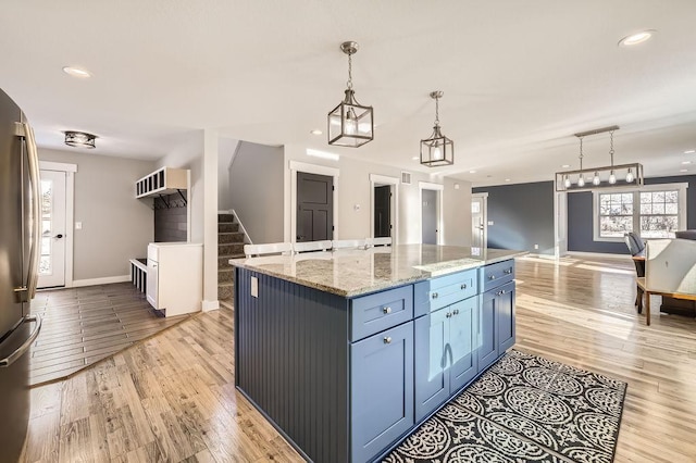 2865 Pilot Knob Rd, Eagan, MN 55121 - kitchen with open floor plan, light wood finished floors, baseboards, hanging light fixtures, and recessed lighting