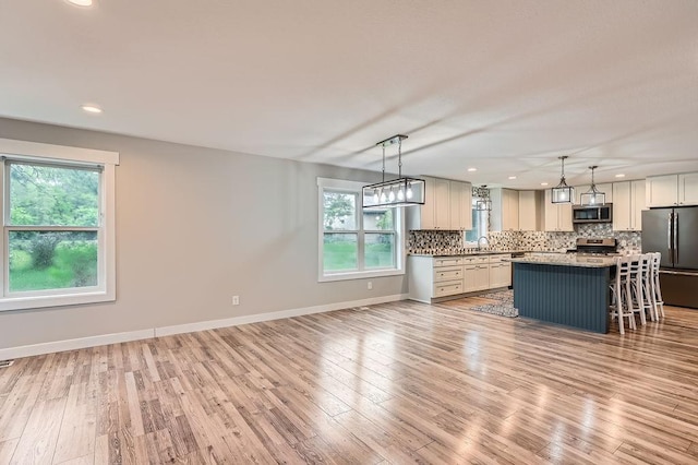 2865 Pilot Knob Rd, Eagan, MN 55121 - kitchen with appliances with stainless steel finishes, tasteful backsplash, a center island, recessed lighting, and hanging light fixtures