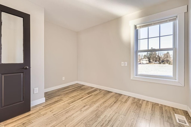 2865 Pilot Knob Rd, Eagan, MN 55121 - spare room with baseboards, healthy amount of natural light, and light wood-type flooring