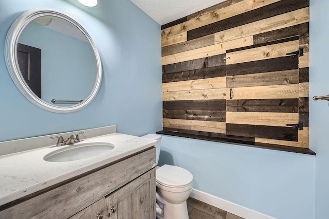 2865 Pilot Knob Rd, Eagan, MN 55121 - bathroom with wooden walls, vanity, and toilet