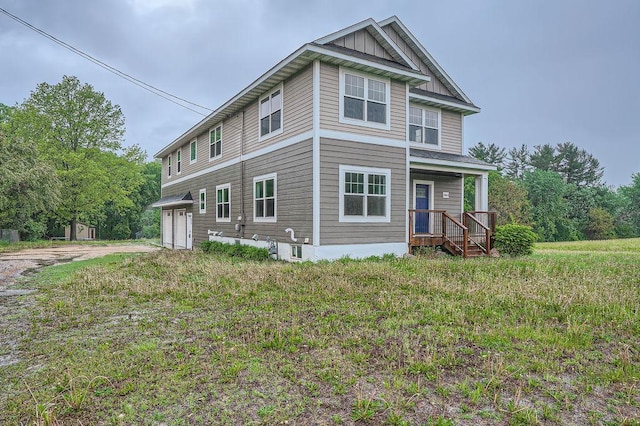2865 Pilot Knob Rd, Eagan, MN 55121 - view of front facade with board and batten siding, driveway, and an attached garage