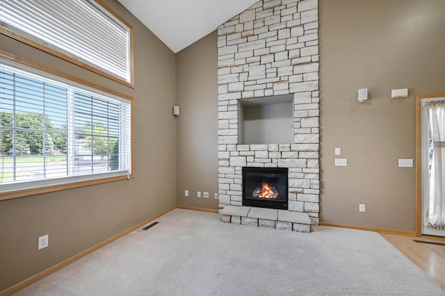 17790 66th Ave N, Maple Grove, MN 55311 - unfurnished living room with vaulted ceiling, a fireplace, and carpet floors