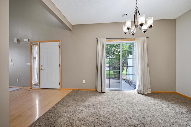 17790 66th Ave N, Maple Grove, MN 55311 - unfurnished room featuring a chandelier, wood finished floors, and carpet floors