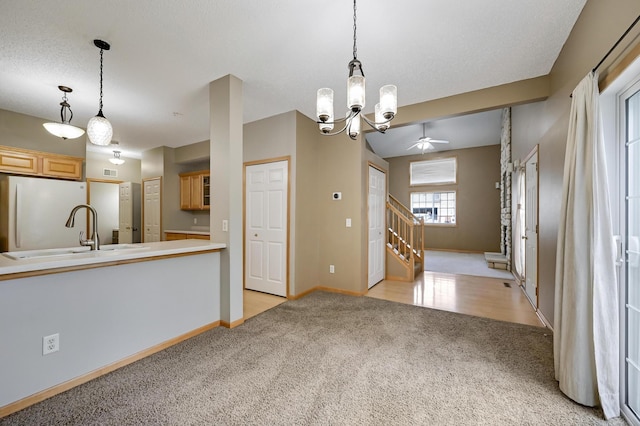 17790 66th Ave N, Maple Grove, MN 55311 - kitchen with freestanding refrigerator, light colored carpet, a chandelier, hanging light fixtures, and light countertops