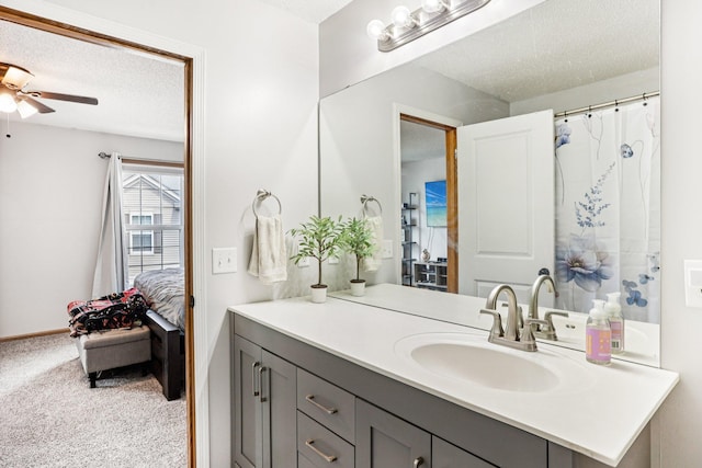 15040 Farnham Ave N, Hugo, MN 55038 - ensuite bathroom featuring vanity, ceiling fan, and a textured ceiling