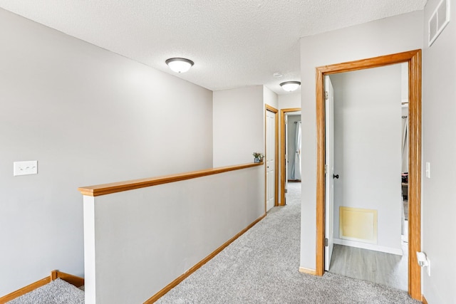 15040 Farnham Ave N, Hugo, MN 55038 - hall with carpet flooring, an upstairs landing, and a textured ceiling
