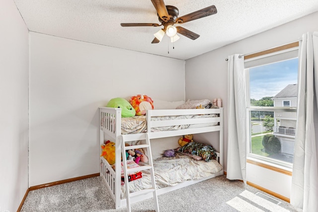 15040 Farnham Ave N, Hugo, MN 55038 - carpeted bedroom with a textured ceiling and a ceiling fan