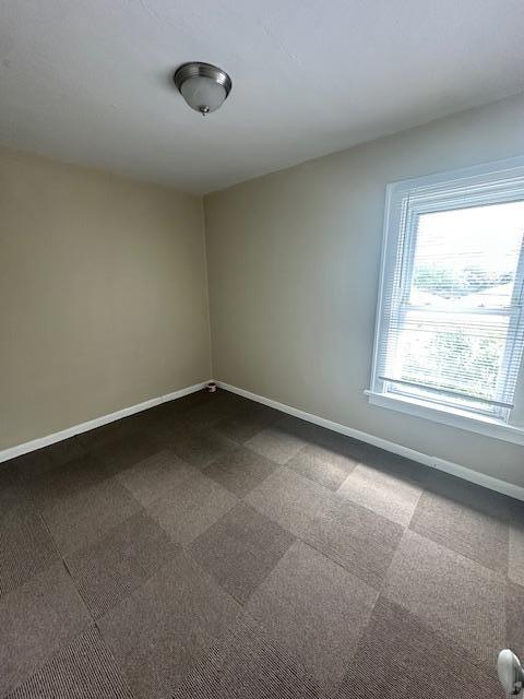 2014 Oakland Ave, Austin, MN 55912 - empty room featuring baseboards and dark carpet