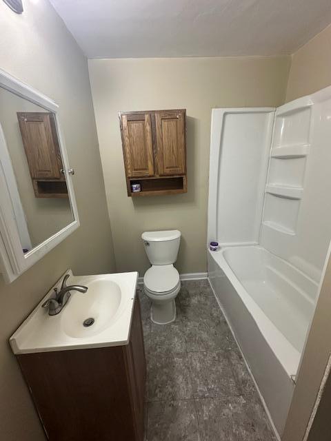2014 Oakland Ave, Austin, MN 55912 - full bathroom featuring vanity, toilet, and baseboards