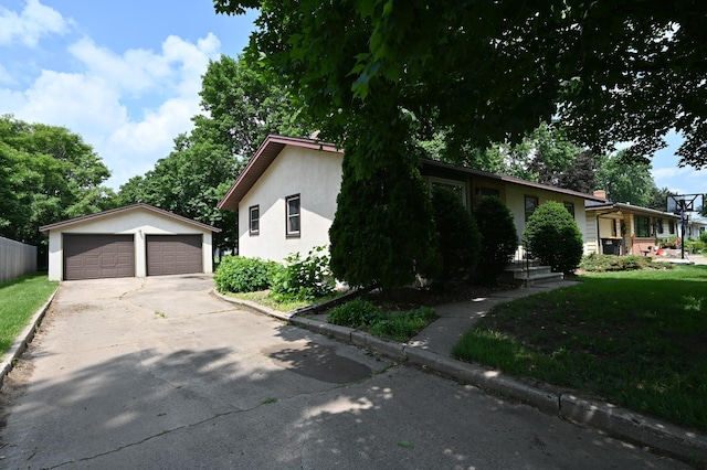 952 Fuller St S, Shakopee, MN 55379 - view of front facade featuring a garage, an outdoor structure, and stucco siding