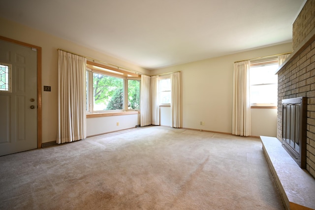 952 Fuller St S, Shakopee, MN 55379 - unfurnished living room with a brick fireplace, light colored carpet, and baseboards