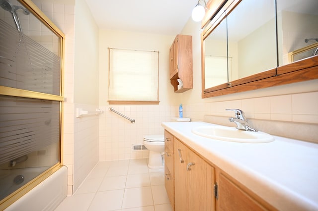 952 Fuller St S, Shakopee, MN 55379 - full bathroom with tile walls, tile patterned flooring, toilet, vanity, and combined bath / shower with glass door