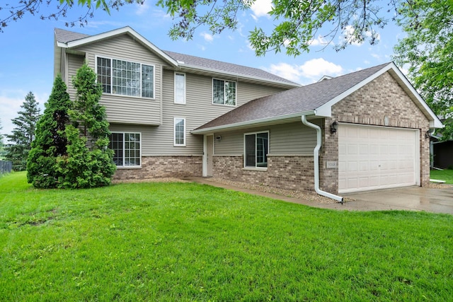3168 Molina St, Shakopee, MN 55379 - back of house with brick siding, a garage, a lawn, and driveway