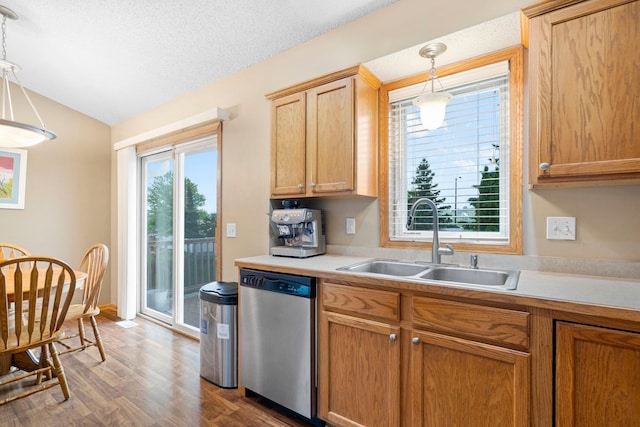 3168 Molina St, Shakopee, MN 55379 - kitchen with stainless steel dishwasher, light countertops, vaulted ceiling, wood finished floors, and decorative light fixtures