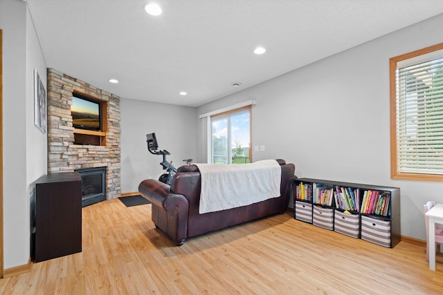 3168 Molina St, Shakopee, MN 55379 - living area with light wood-style flooring, a fireplace, and recessed lighting