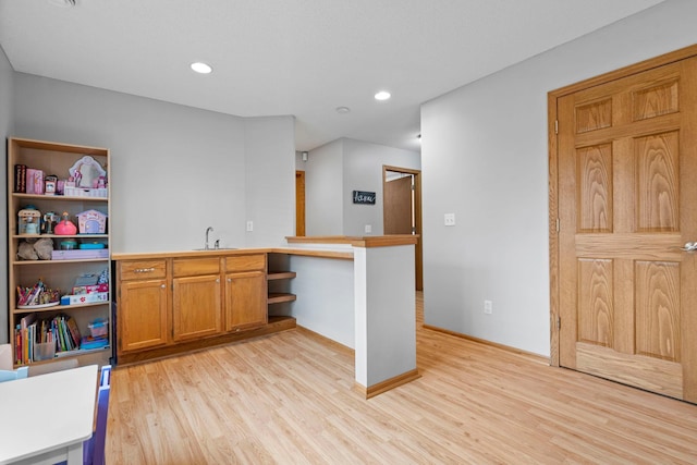 3168 Molina St, Shakopee, MN 55379 - kitchen featuring light wood-type flooring, open shelves, brown cabinetry, recessed lighting, and light countertops