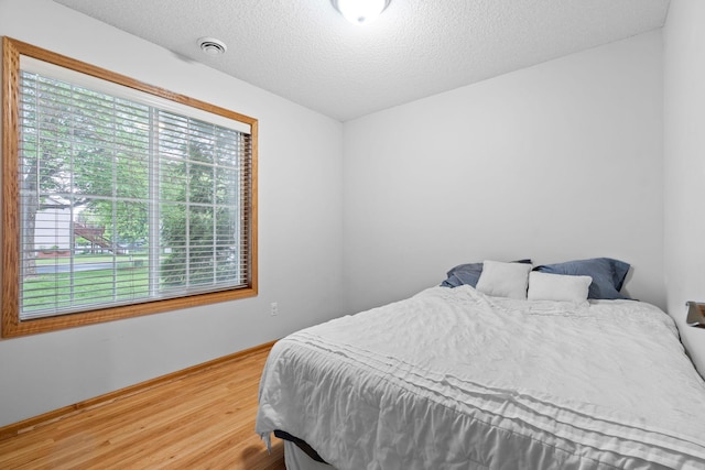 3168 Molina St, Shakopee, MN 55379 - bedroom with wood finished floors and a textured ceiling