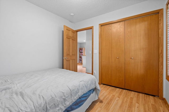 3168 Molina St, Shakopee, MN 55379 - bedroom with light wood finished floors, a closet, and a textured ceiling