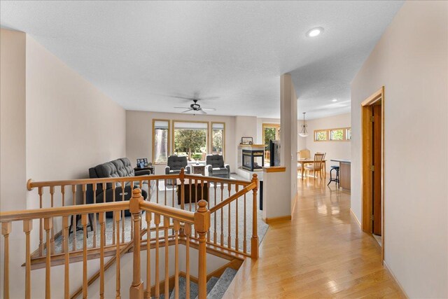 1195 64th St, Hudson, WI 54016 - corridor featuring an upstairs landing, plenty of natural light, light wood-style flooring, and recessed lighting
