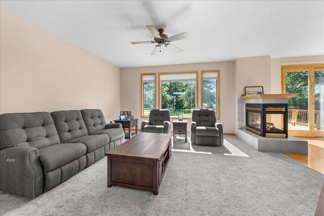 1195 64th St, Hudson, WI 54016 - living area featuring a tile fireplace, ceiling fan, and carpet flooring