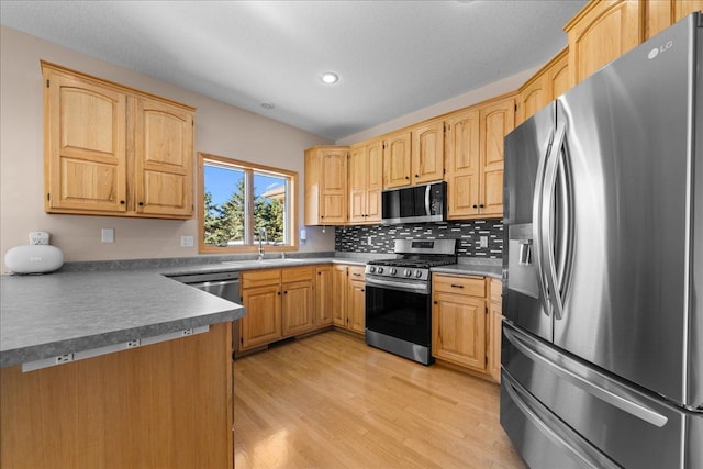 1195 64th St, Hudson, WI 54016 - kitchen featuring appliances with stainless steel finishes, light wood-type flooring, recessed lighting, tasteful backsplash, and light brown cabinetry