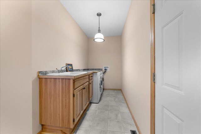 1195 64th St, Hudson, WI 54016 - laundry area featuring washer / clothes dryer, cabinet space, and light tile patterned flooring